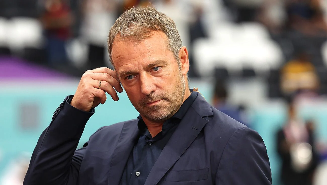  A picture of Hansi Flick, the coach of the German national football team, looking stressed with his hand on his head during a match against Spain at the 2022 World Cup in Qatar.